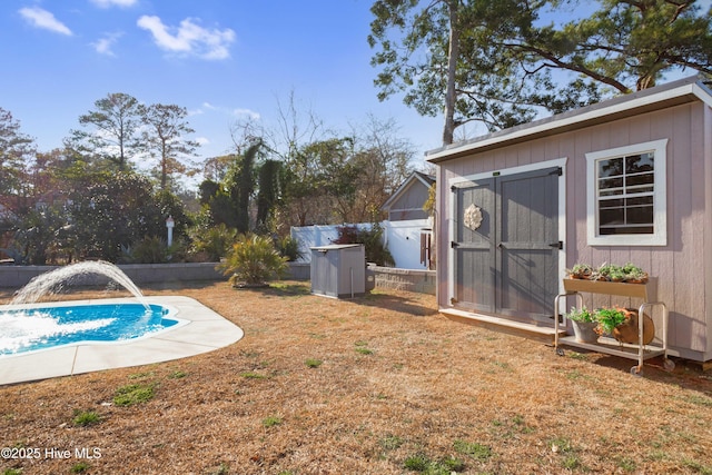 view of pool with a storage shed, an outdoor structure, fence, a lawn, and a fenced in pool