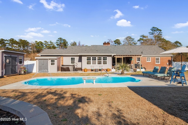 view of pool featuring a storage shed, an outdoor structure, fence, and a fenced in pool