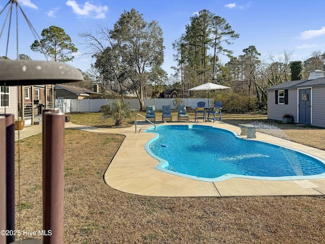 view of pool featuring an outbuilding, a patio area, a fenced backyard, and a fenced in pool