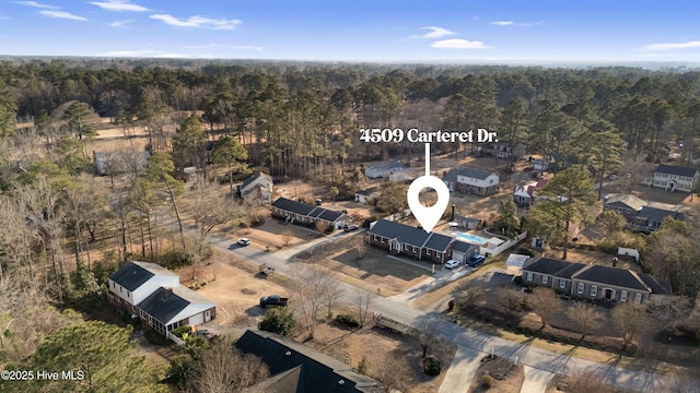 birds eye view of property with a wooded view