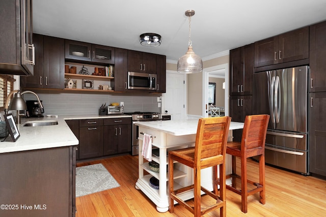 kitchen with open shelves, a sink, dark brown cabinetry, and stainless steel appliances