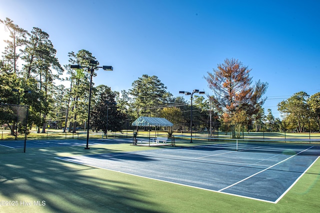 view of tennis court featuring fence