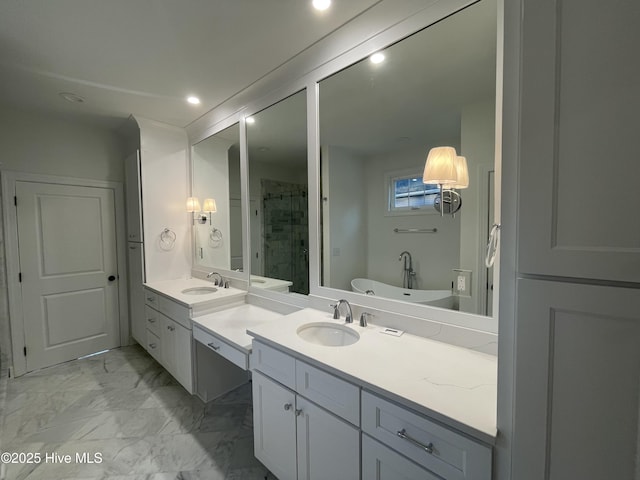 bathroom featuring a stall shower, marble finish floor, two vanities, and a sink