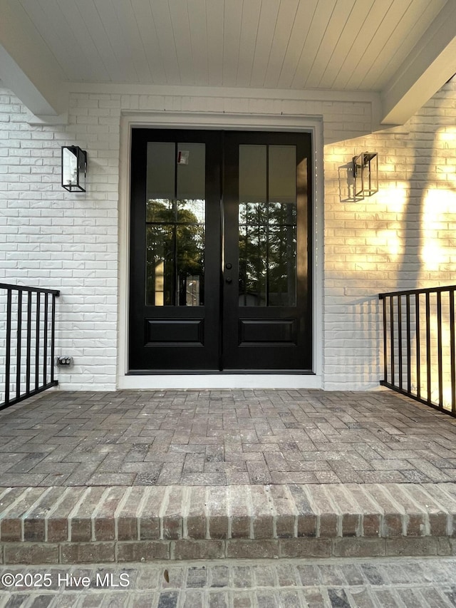 entrance to property with french doors and brick siding