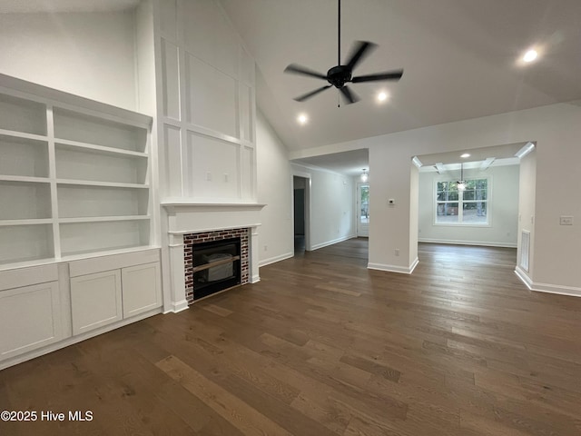 unfurnished living room with dark wood-type flooring, a fireplace, ceiling fan, and baseboards