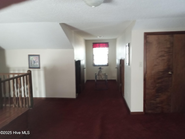 hallway featuring carpet flooring and an upstairs landing