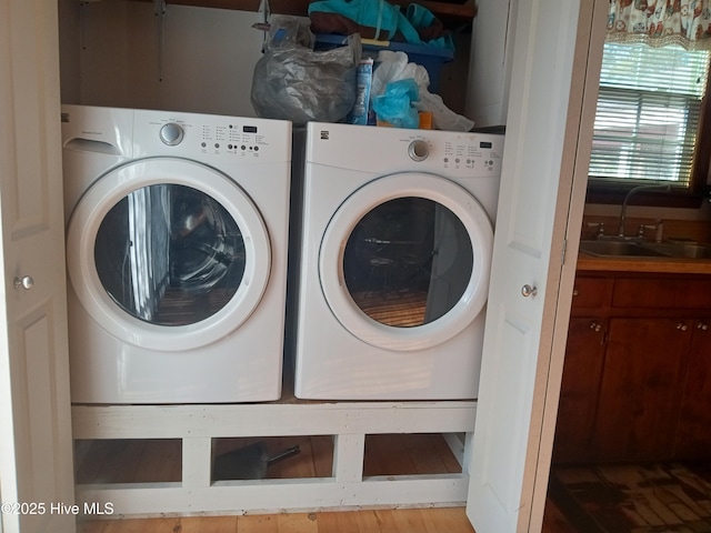 laundry room with washing machine and dryer, laundry area, and a sink