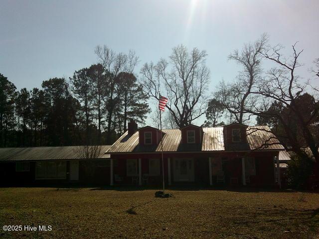 back of house with metal roof