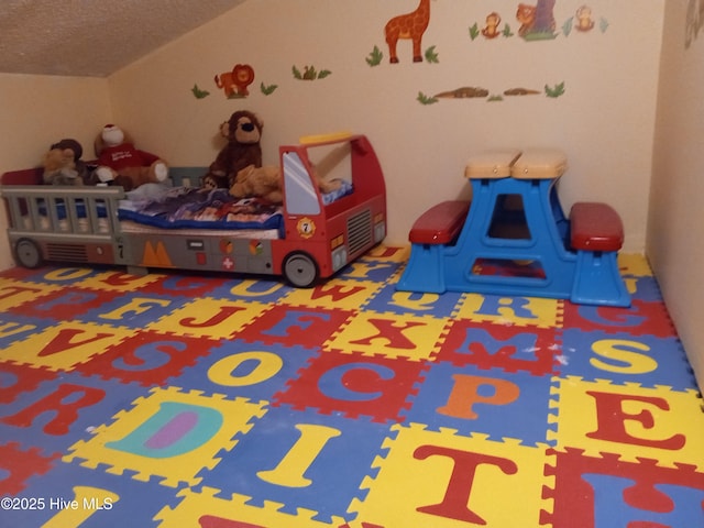 bedroom with carpet and vaulted ceiling