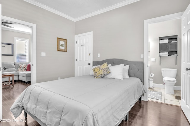 bedroom with baseboards, wood finished floors, connected bathroom, and crown molding