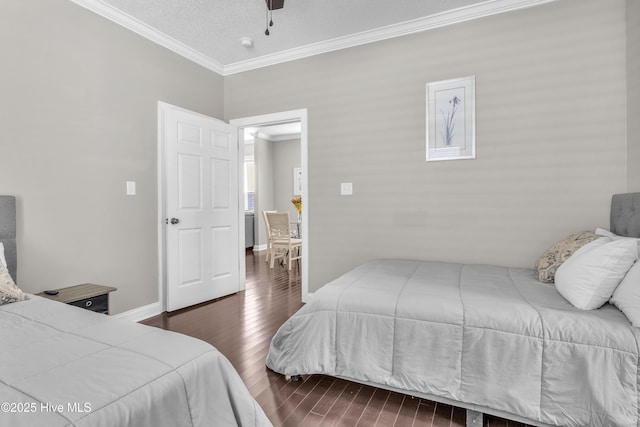 bedroom featuring dark wood-style floors, crown molding, baseboards, and ceiling fan