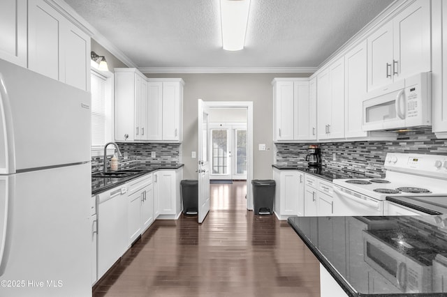 kitchen featuring dark wood finished floors, white appliances, white cabinetry, and a sink