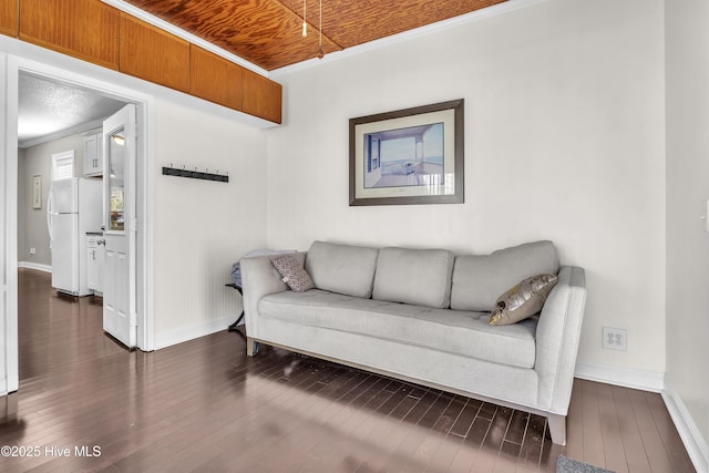 living area featuring wooden ceiling, dark wood-style floors, baseboards, and crown molding