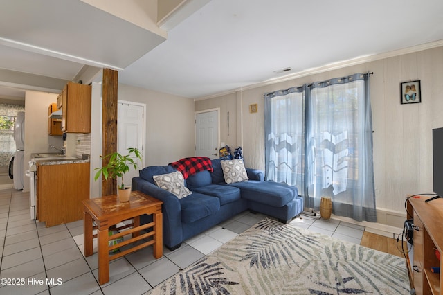 living area with light tile patterned floors and visible vents