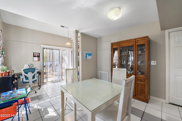 dining room featuring light tile patterned floors, visible vents, and baseboards