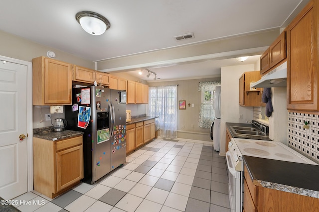 kitchen featuring white appliances, visible vents, light tile patterned flooring, a sink, and under cabinet range hood