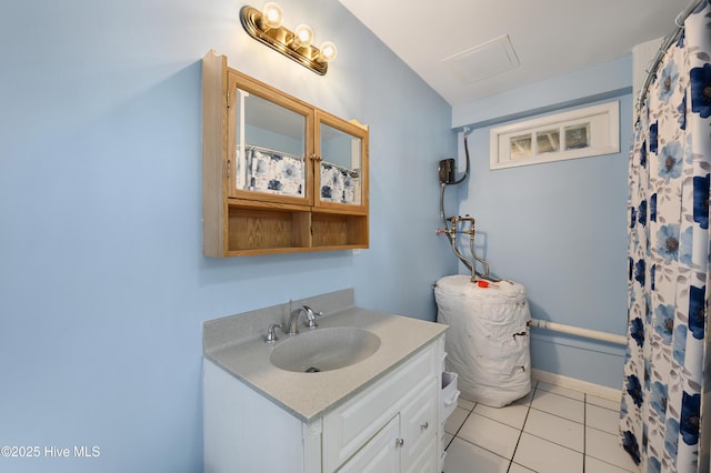 bathroom featuring vanity, tile patterned floors, and baseboards