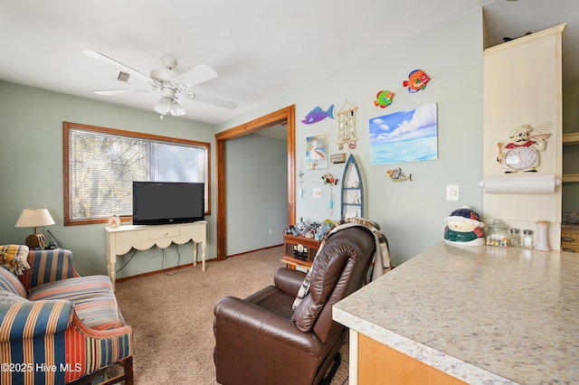 carpeted living room with visible vents, baseboards, and ceiling fan