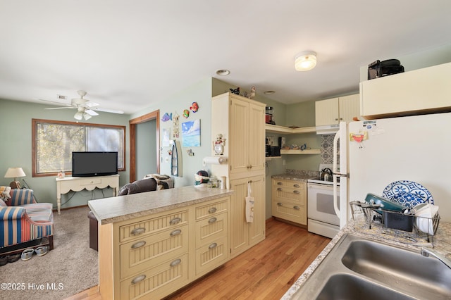 kitchen with white appliances, cream cabinetry, a peninsula, and open shelves