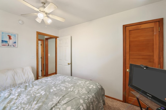 bedroom with baseboards, carpet floors, and a ceiling fan