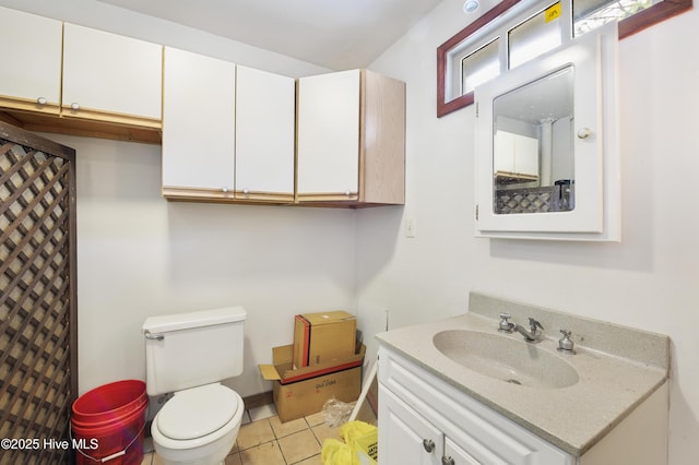 bathroom with vanity, tile patterned floors, and toilet