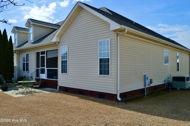 view of property exterior with crawl space and a patio area