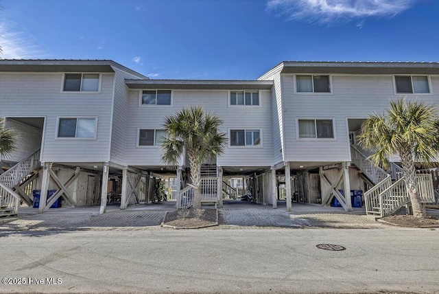 view of front of home featuring stairway and a carport