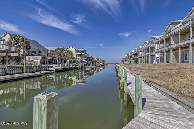 view of dock with a residential view and a water view