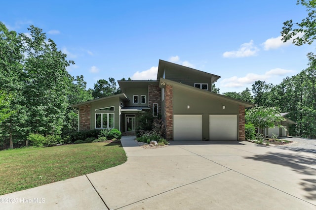 mid-century modern home with driveway, a garage, and a front lawn