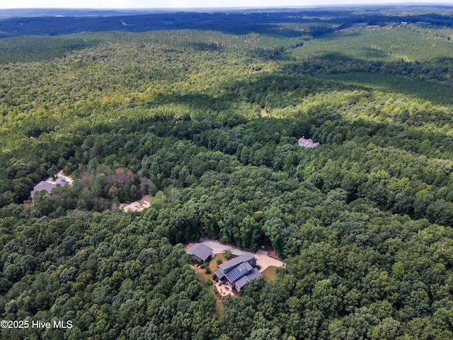 bird's eye view featuring a wooded view