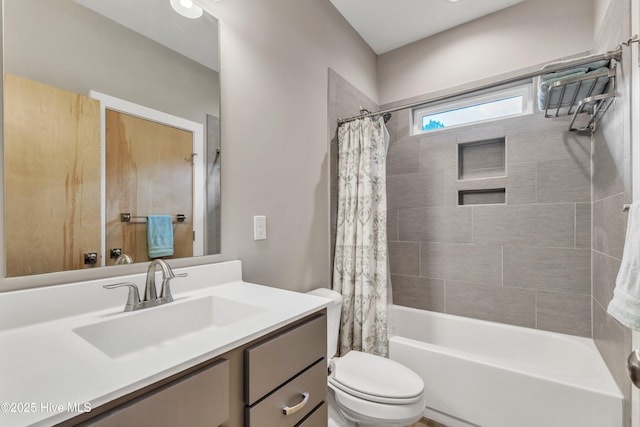 full bathroom featuring shower / tub combo, vanity, and toilet