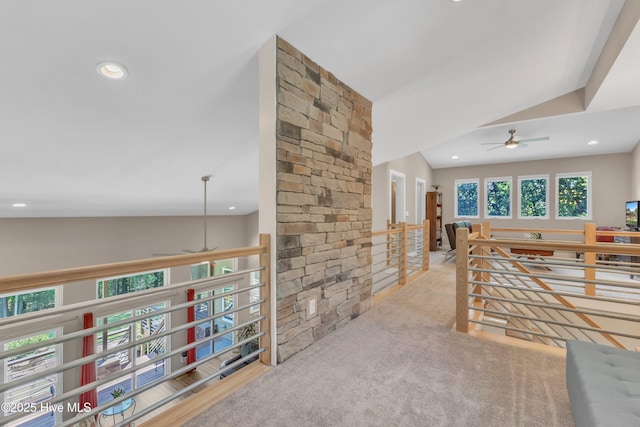 hallway featuring recessed lighting, light colored carpet, and an upstairs landing