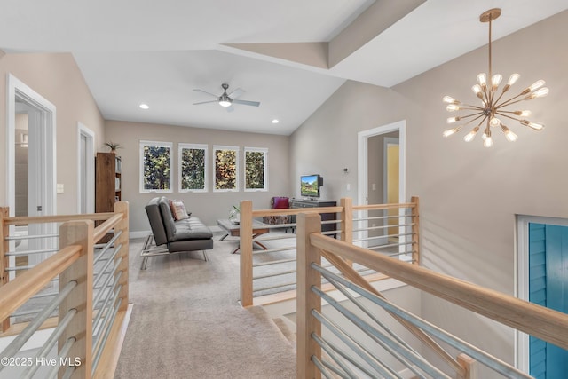 corridor featuring light carpet, vaulted ceiling, a notable chandelier, and an upstairs landing