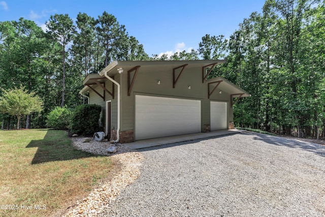 view of side of home with a yard