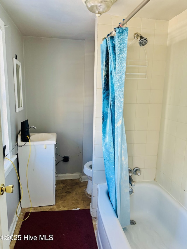 bathroom featuring baseboards, vanity, toilet, and shower / bathtub combination with curtain