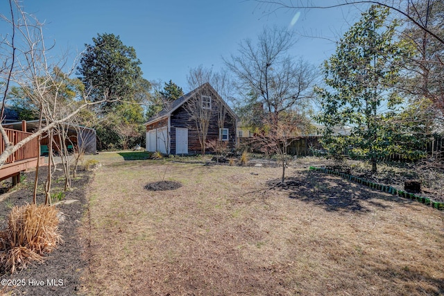 view of yard with an outbuilding, fence, and a garage