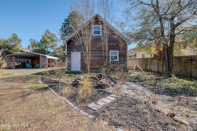 exterior space featuring a front lawn and fence