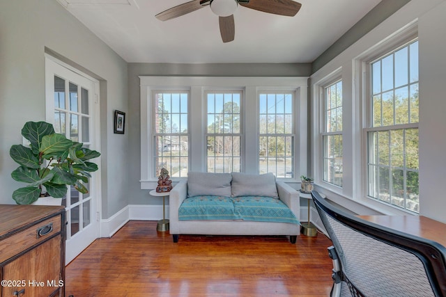 sunroom / solarium featuring ceiling fan