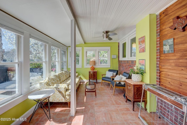 sunroom / solarium featuring ceiling fan