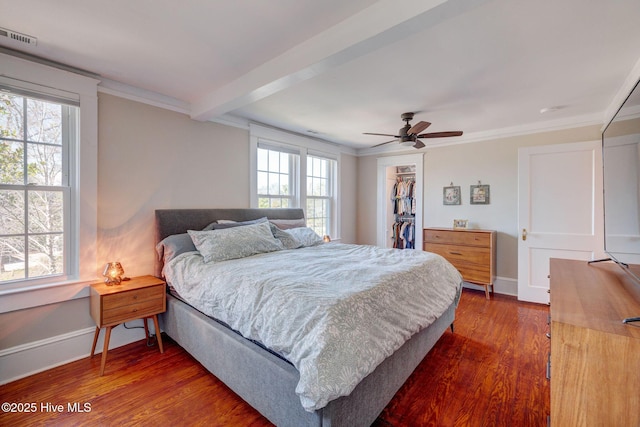 bedroom featuring dark wood-type flooring, baseboards, and ornamental molding