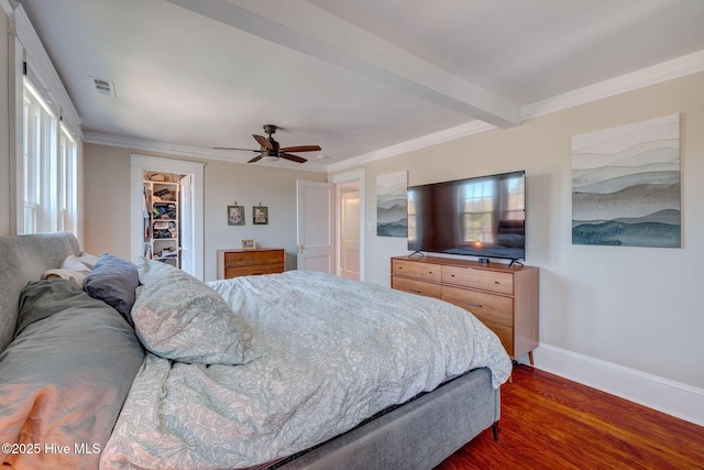 bedroom featuring beamed ceiling, baseboards, dark wood-style floors, and ornamental molding