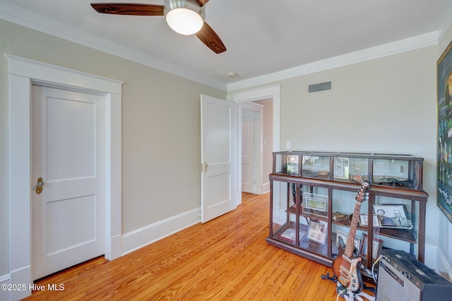 office space featuring visible vents, light wood-style floors, and crown molding