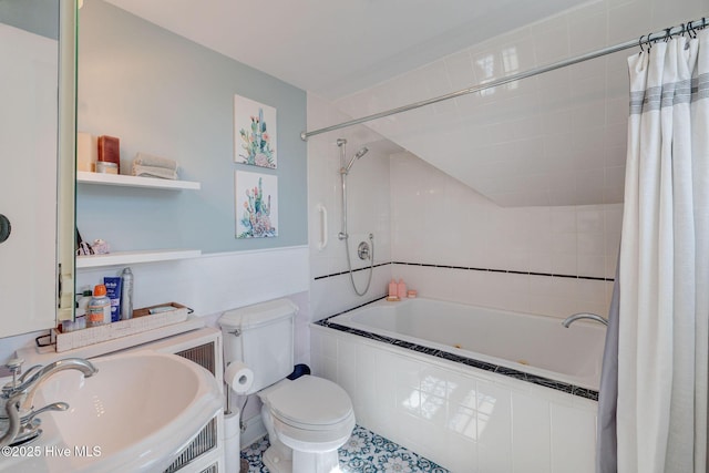 full bathroom with a sink, toilet, and tiled shower / bath combo