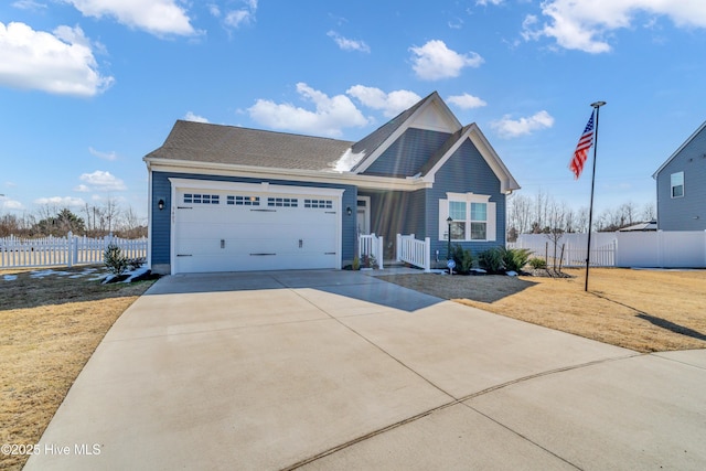 view of front of house with a garage, fence, and driveway