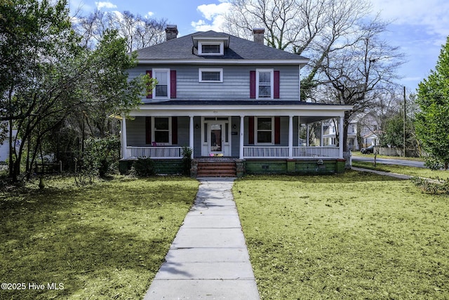 view of front of home with a porch, roof with shingles, a chimney, and a front lawn