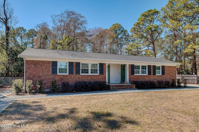 single story home featuring fence, a front lawn, and brick siding