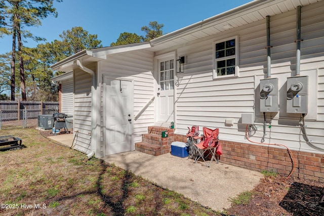 exterior space featuring entry steps and fence