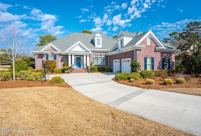 view of front of house featuring a garage, driveway, and brick siding