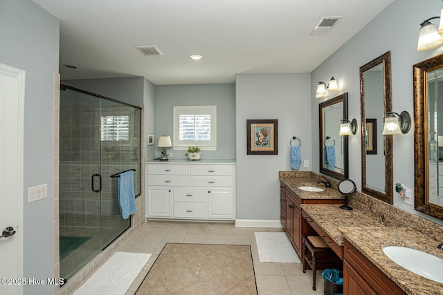 full bathroom featuring a shower stall, vanity, visible vents, and tile patterned floors