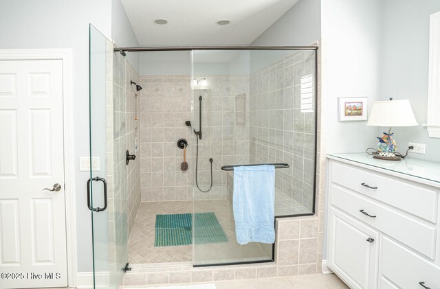 full bathroom featuring a stall shower and tile patterned flooring